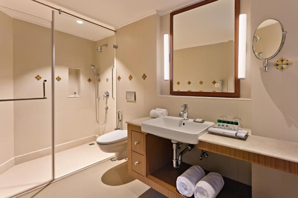 a bathroom with a sink and a shower and a toilet at Welcomhotel by ITC Hotels, Bay Island, Port Blair in Port Blair