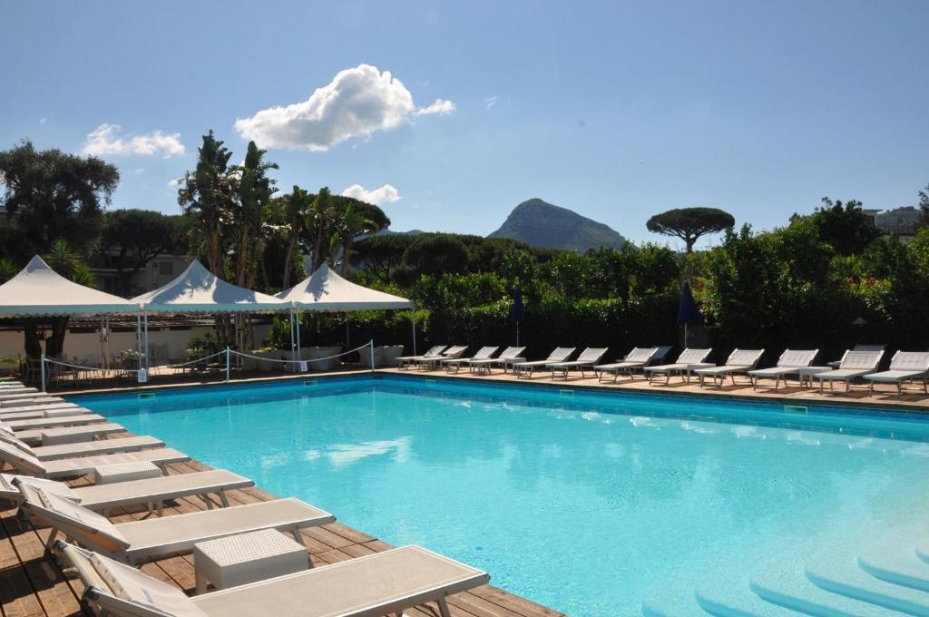 a swimming pool with chaise lounge chairs and a resort at Esperidi Resort in Sant'Agnello