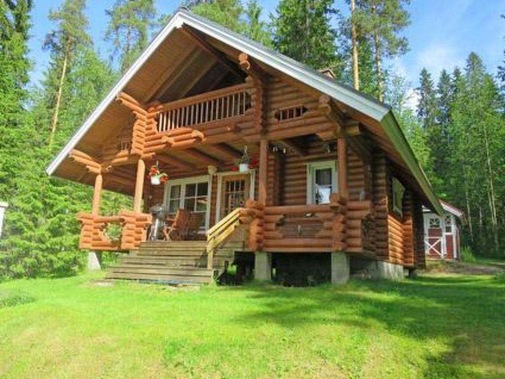 eine Blockhütte im Wald mit einer Veranda und einer Treppe in der Unterkunft Holiday Home Lepolahti by Interhome in Virrat