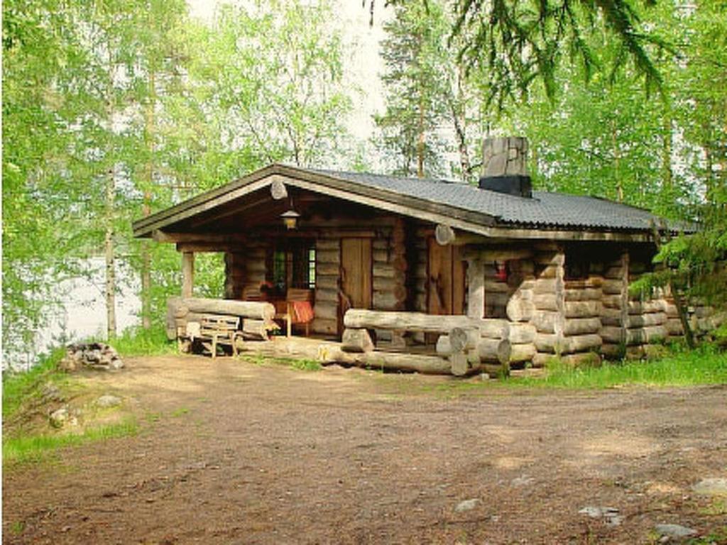 a log cabin in the middle of a forest at Holiday Home Mäkitorppa by Interhome in Pätiälä