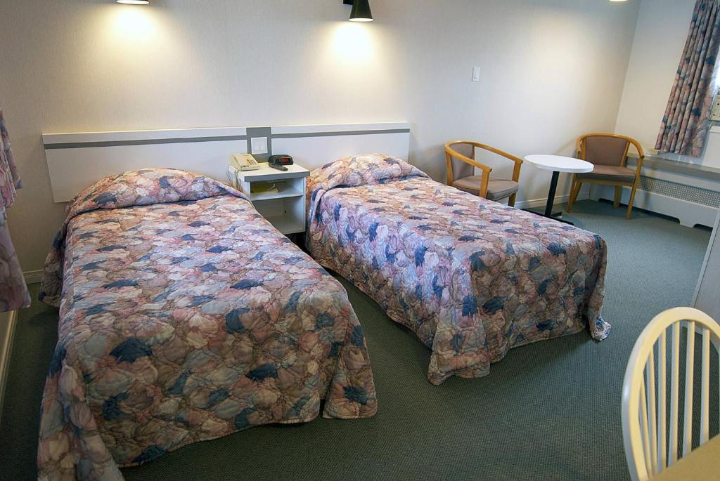 Postel nebo postele na pokoji v ubytování Daigle's Motel