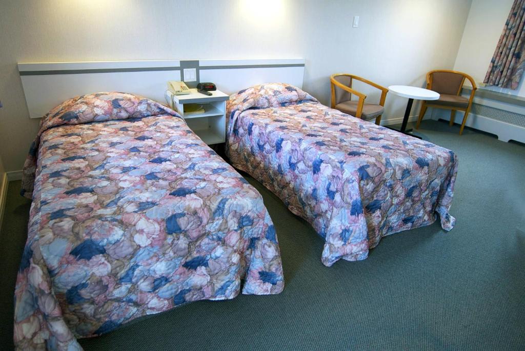 Postel nebo postele na pokoji v ubytování Daigle's Motel