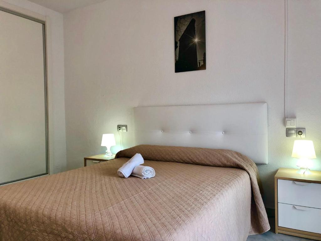 a bedroom with a bed with a towel on it at Apartamentos Las Rosas de Capistrano in Nerja