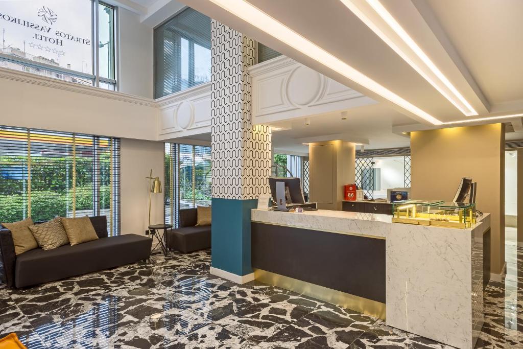 a lobby with a reception desk in a building at Airotel Stratos Vassilikos Hotel in Athens
