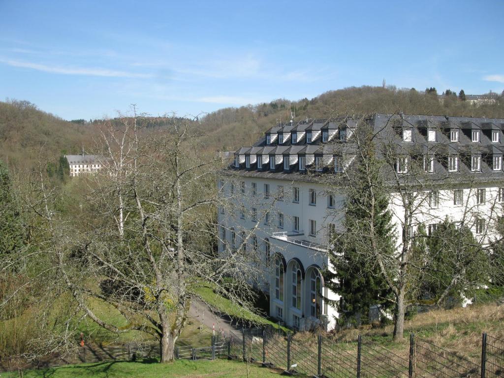 a large white building on top of a hill at Traumblick Vallendar in Vallendar