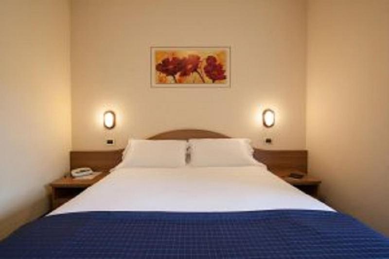 Postel nebo postele na pokoji v ubytování Hotel Prealpi