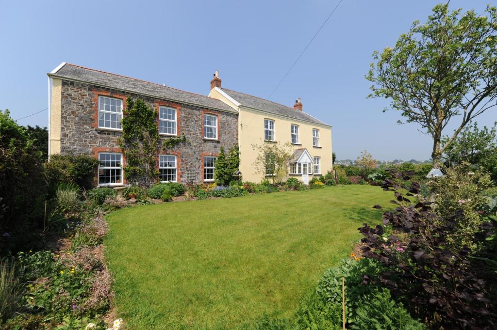 a house with a large lawn in front of it at Ford Down Farm B&B in South Molton