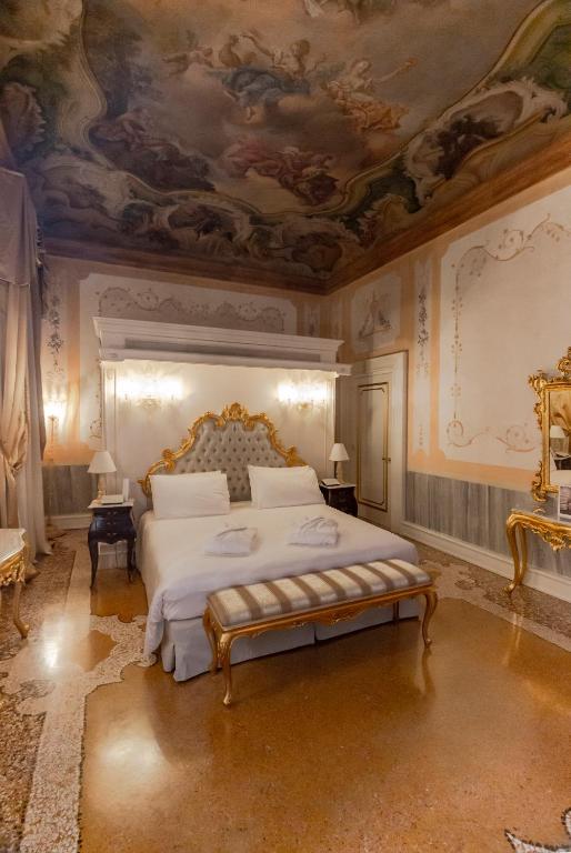 a bedroom with a bed with a painting on the ceiling at Ca' Bonfadini Historic Experience in Venice