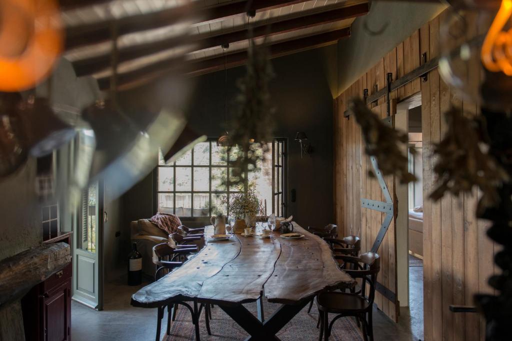 a large wooden table in a room with chairs at Opora Country Living in Nafplio