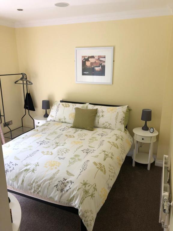 a bedroom with a bed with a white comforter at 9 The Net Lofts in Mevagissey