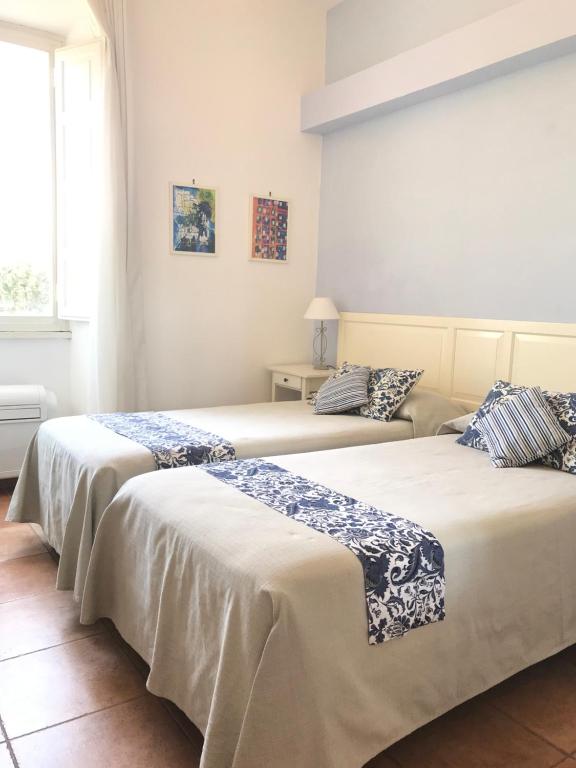 two beds sitting next to each other in a room at Il Miraggio in Fregene