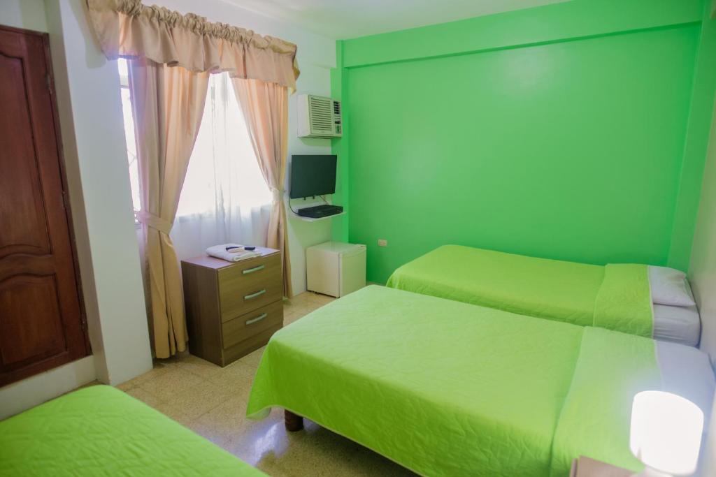 Postel nebo postele na pokoji v ubytování North Star Hostal Guayaquil