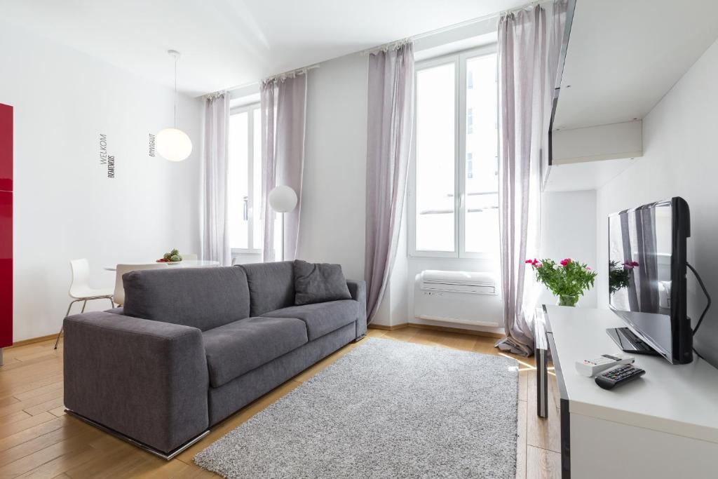 un salon avec un canapé et une télévision dans l'établissement Le St Honoré, à Cannes