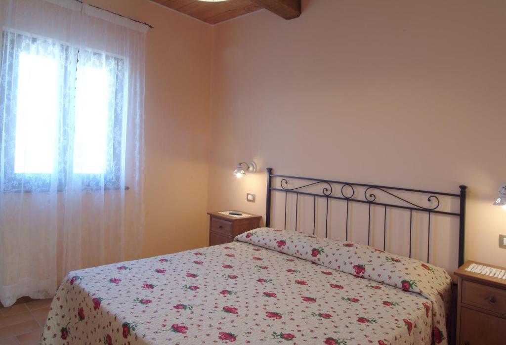 Postel nebo postele na pokoji v ubytování Agriturismo Le Ginestre