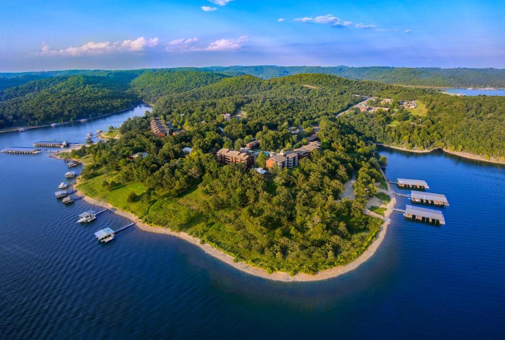 an island in the water with houses and boats at Still Waters Resort in Branson
