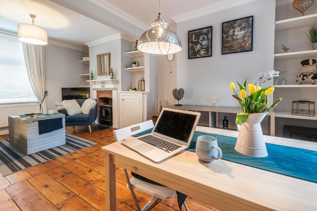 a laptop on a desk in a living room at Regal House Exeter in Exeter