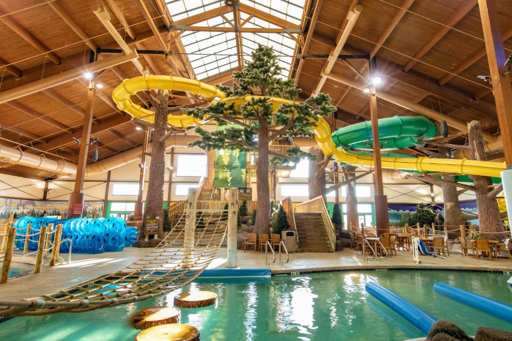 a pool with a slide in a water park at Timber Ridge Lodge and Waterpark in Lake Geneva