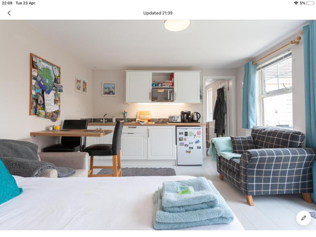 a room with a kitchen and a living room at The Studio Castlerock with Hot Tub in Coleraine