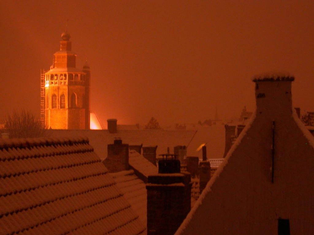 a building with a clock tower at night at B&B 't Walleke in Bruges