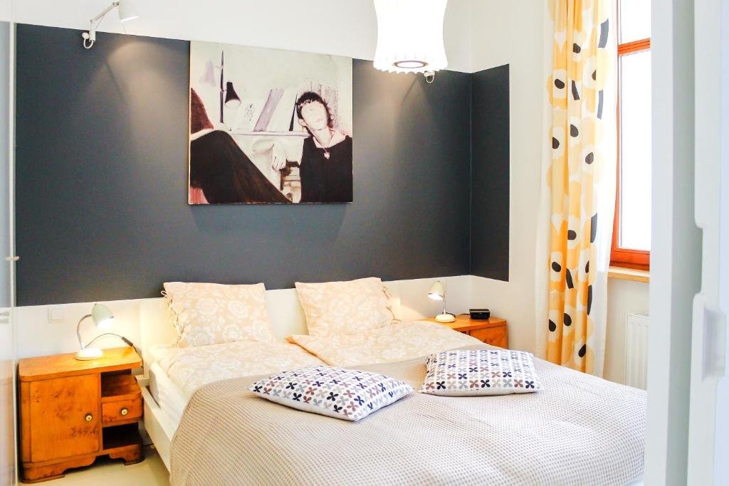 a bedroom with a bed with two pillows on it at Apartament Relax Neptun Park in Gdańsk