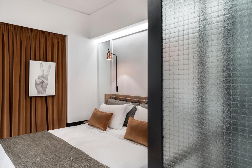 Postel nebo postele na pokoji v ubytování Niki Athens Hotel