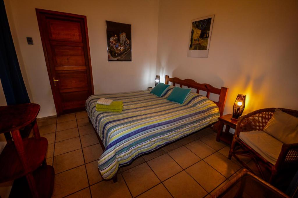 Postel nebo postele na pokoji v ubytování Hostal El Punto