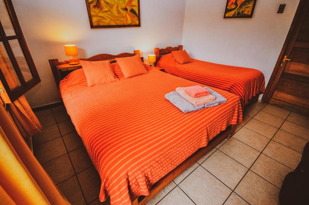 Postel nebo postele na pokoji v ubytování Hostal El Punto