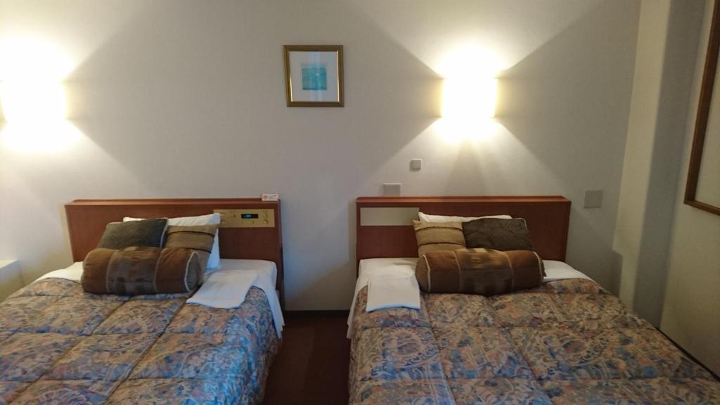 Postel nebo postele na pokoji v ubytování Kuretake-Inn Iwata
