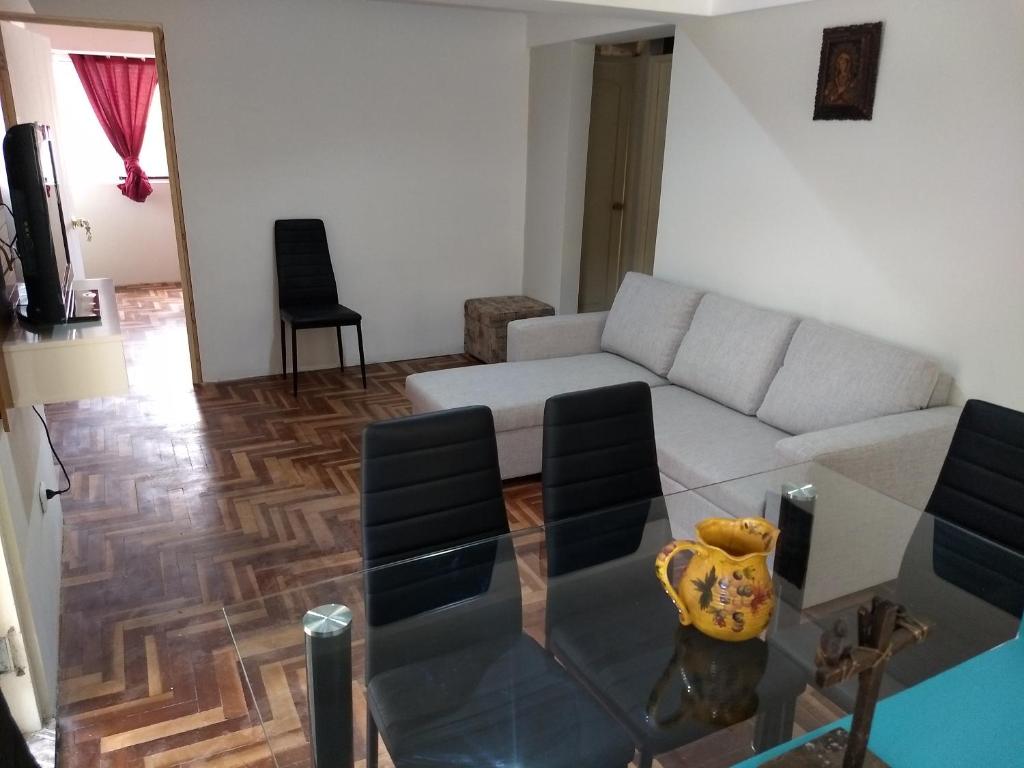 uma sala de estar com um sofá e uma mesa de vidro em Cusco`s Flat 2 em Cusco