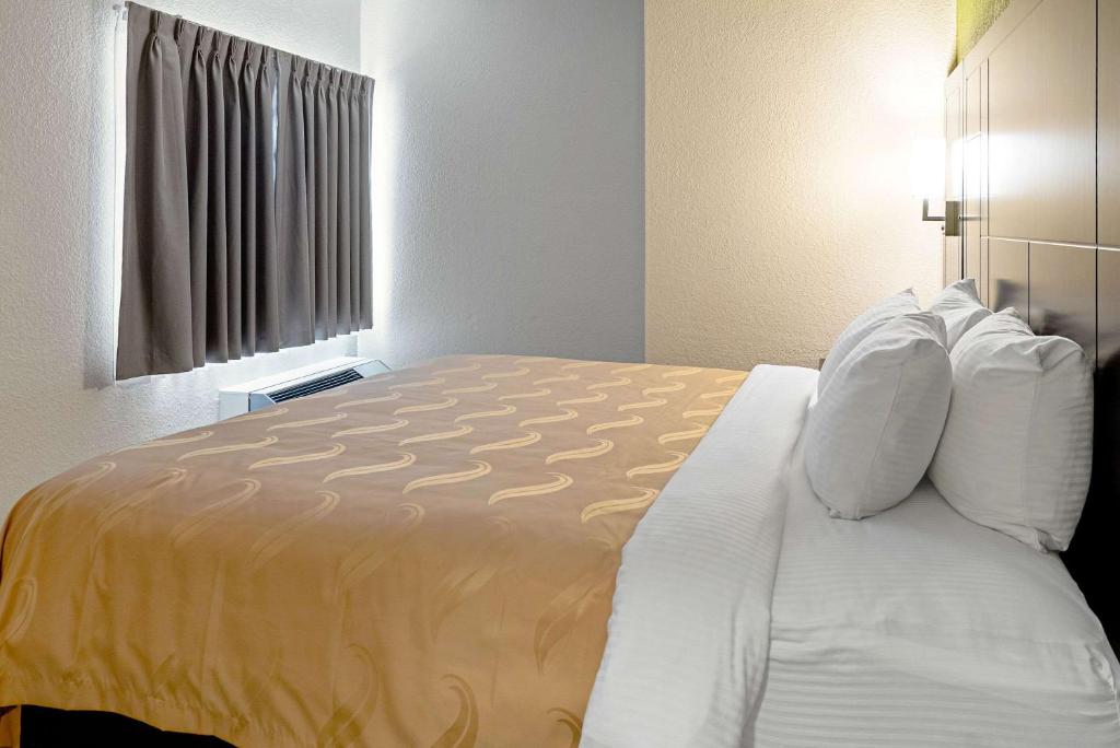 a hotel room with a large bed in a room at Quality Inn & Suites in Robbinsville