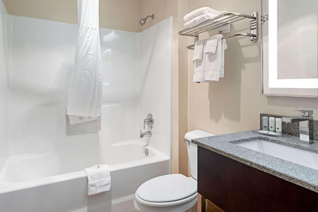 a white bathroom with a toilet and a sink at Quality Inn & Suites in Robbinsville