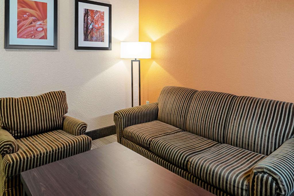 a living room with two couches and a table at Quality Inn & Suites in Robbinsville