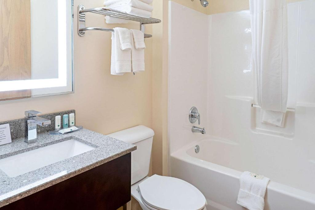 a bathroom with a sink and a toilet and a tub at Quality Inn & Suites in Robbinsville