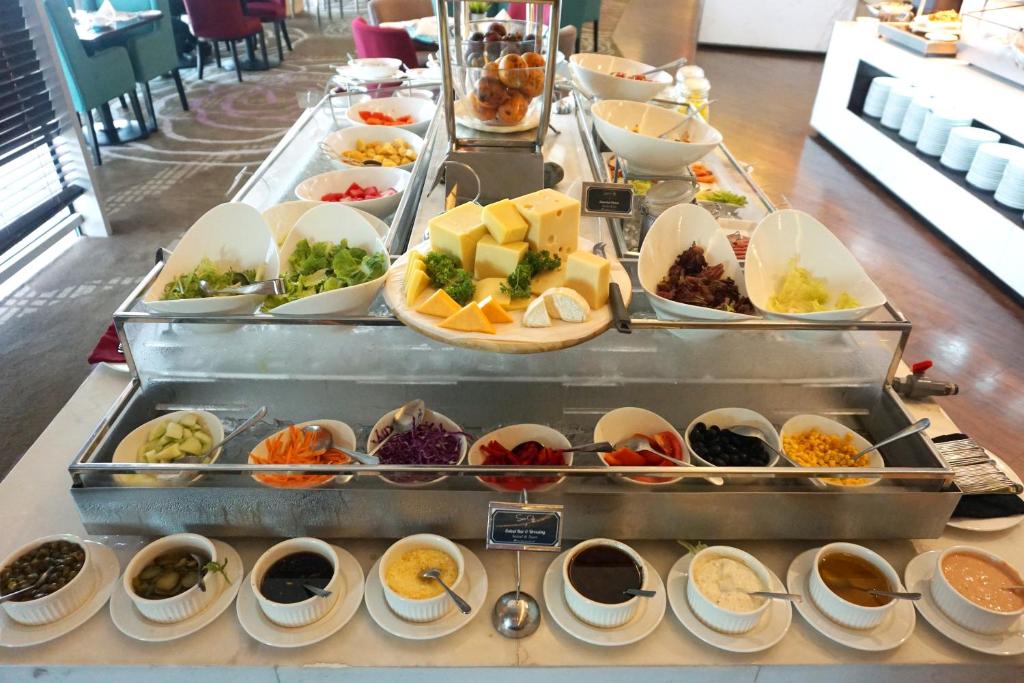 a buffet line with many different types of food at Swiss-Belhotel Airport Jakarta in Tangerang