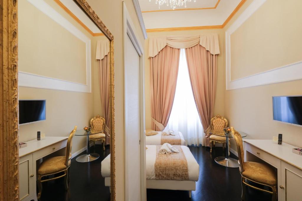 a hotel room with a mirror and a bed at B&B Kingsman in Florence