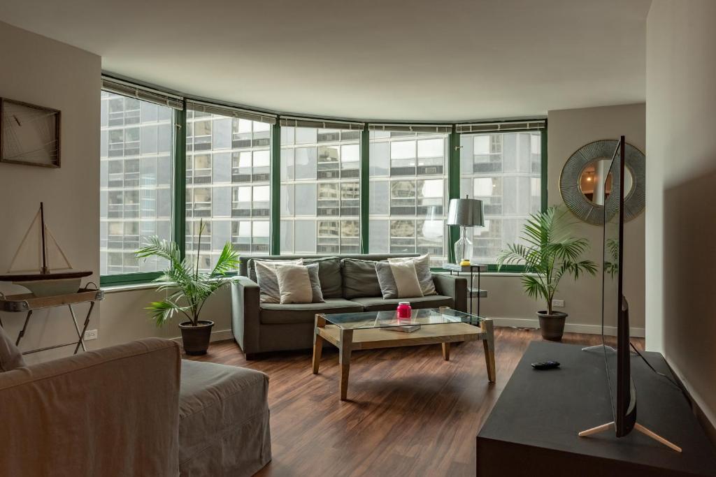 a living room with a couch and a table at ENVITAE 3BR Downtown Luxurious Suite Views & Pool in Chicago