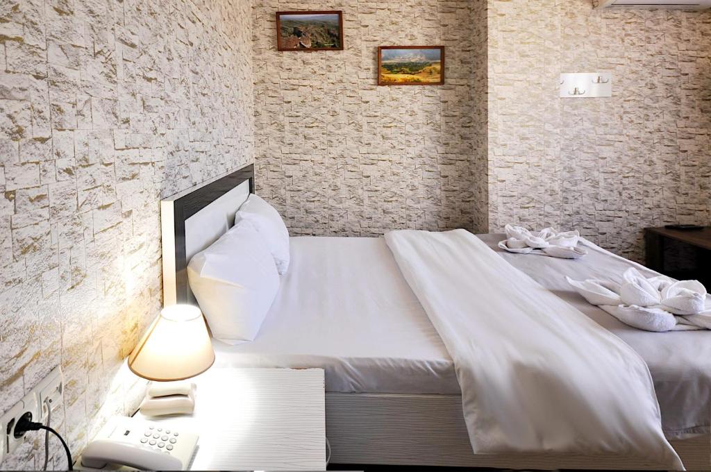 Postel nebo postele na pokoji v ubytování Hotel Kavela