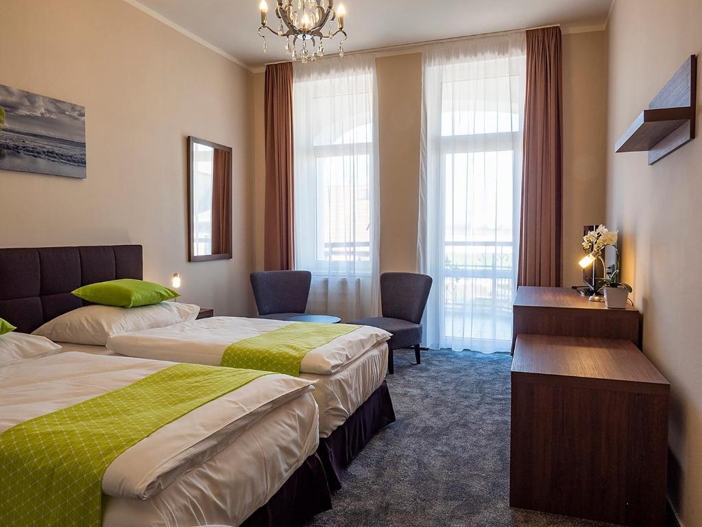 Un pat sau paturi într-o cameră la Hotel Olympia Česká Lípa