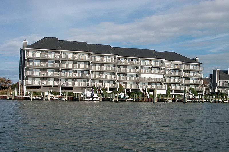 a large building on the water next to a body of water at Harbour Island 302L in Ocean City