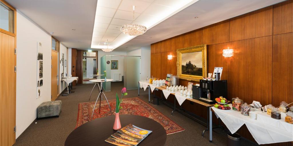 a conference room with tables and chairs in a building at At the Park Hotel in Baden