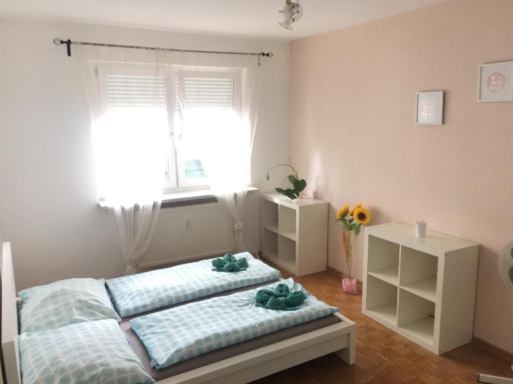 a bedroom with two beds and a window at Apartment4you in Graz