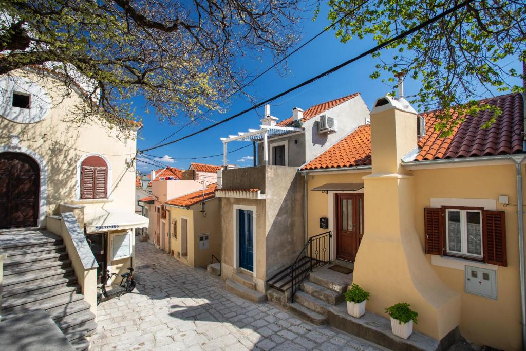 a row of houses on a cobblestone street at Little house in Baška in Baška