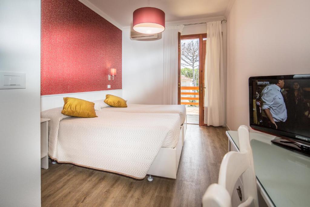 Postel nebo postele na pokoji v ubytování Hotel Capanna d'Oro
