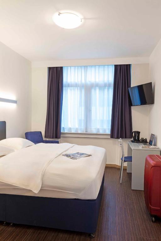Postel nebo postele na pokoji v ubytování Hôtel Argus by happyCulture