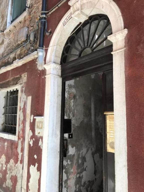 an entrance to a building with a glass door at Luxury Venetian Rooms in Venice