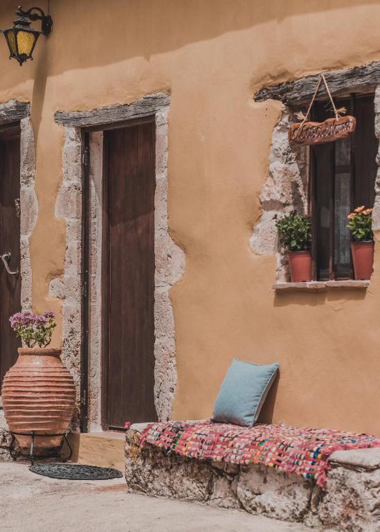a couch sitting outside of a building with a window at La Casa Di Nonna in Koríthion