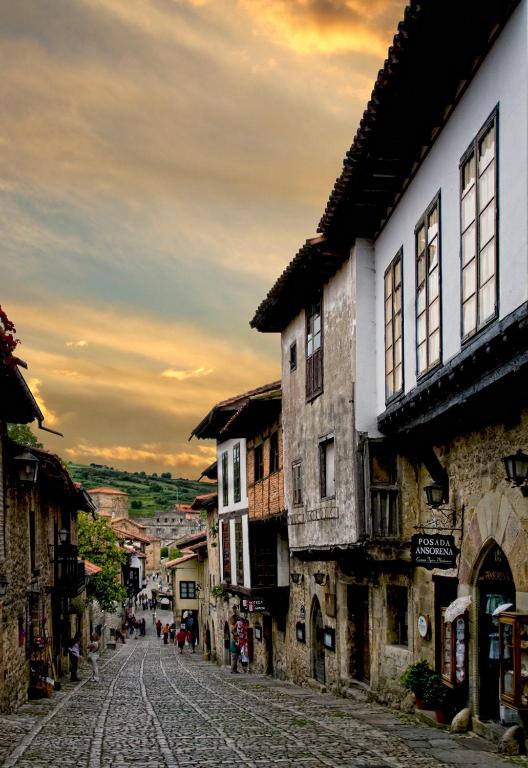 an old street in a medieval town with buildings at Posada Ansorena in Santillana del Mar