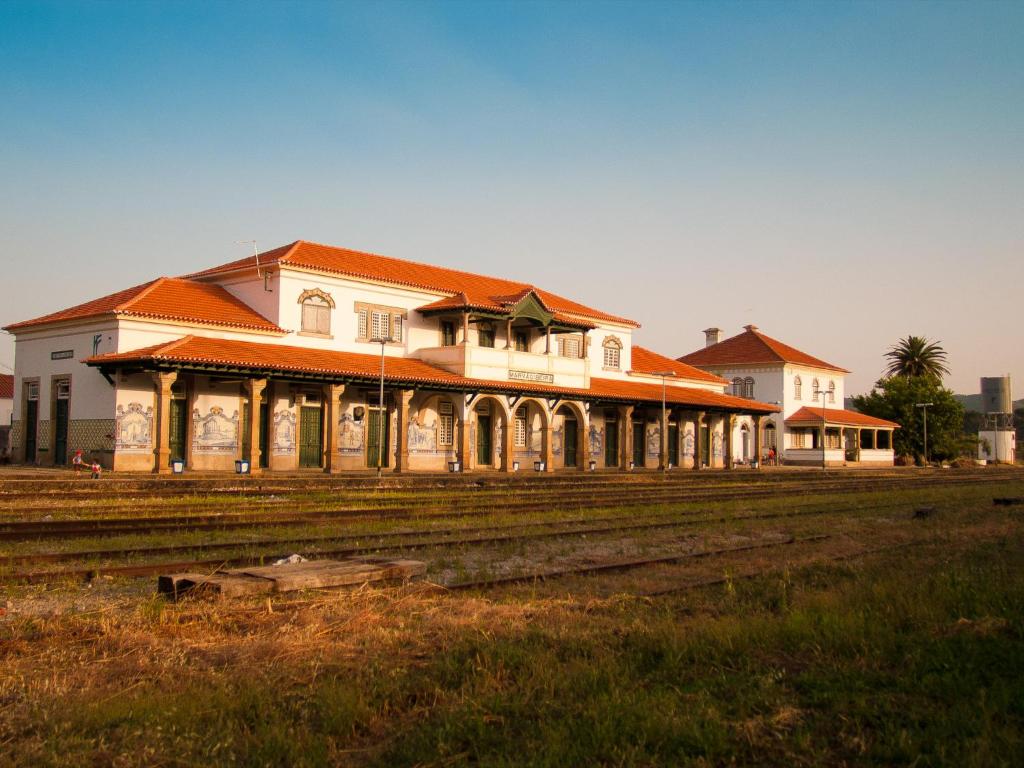 馬爾旺的住宿－火車站旅館，一座建筑,在田野旁边有一个橙色的屋顶