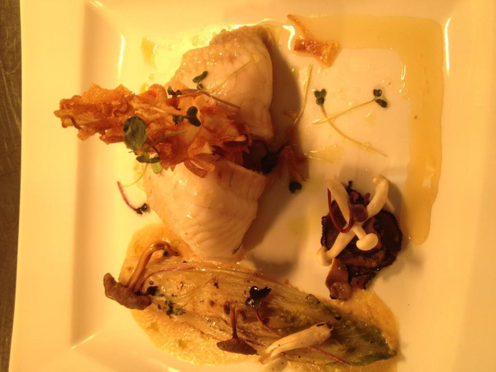 a plate of food with ice cream and vegetables at Sutherland House in Southwold