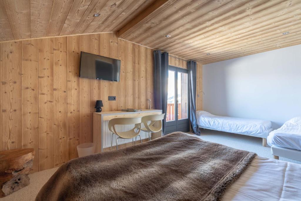 Postel nebo postele na pokoji v ubytování Chalet Les Rhodos